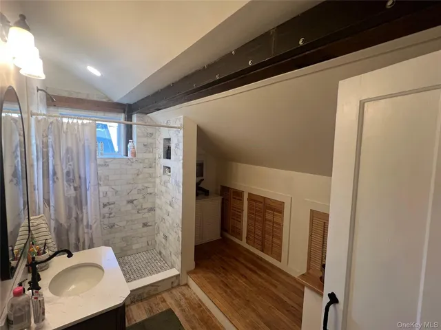 a bathroom with a shower and a sink