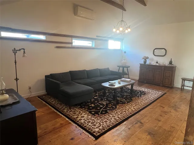a living room with a couch and a chandelier