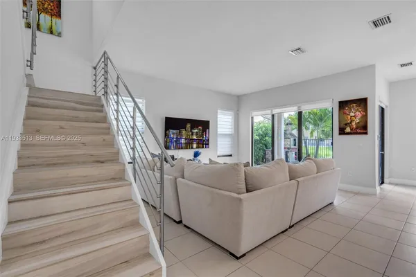 a living room with furniture and a large window