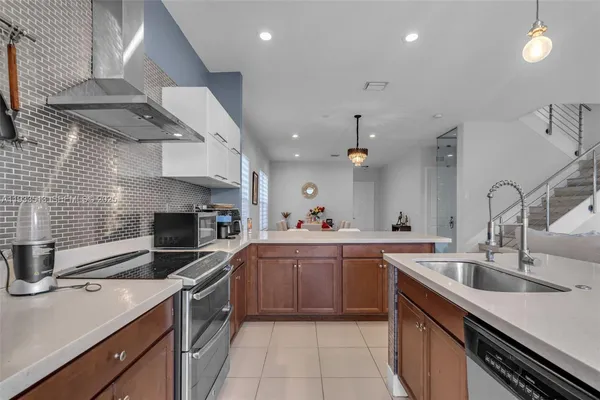 a kitchen with a sink stainless steel appliances and cabinets