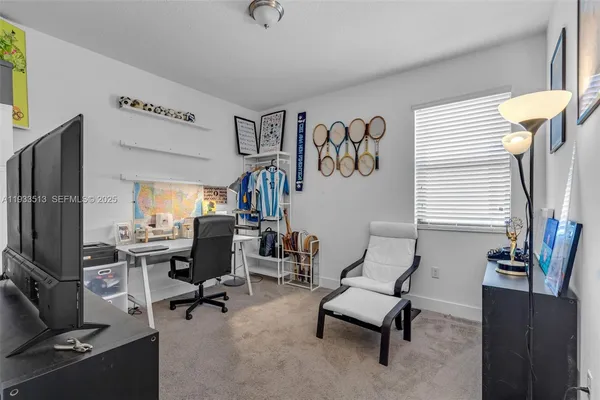 a view of a livingroom with workspace and a window