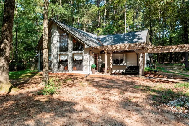 a wooden bench sitting in front of a building