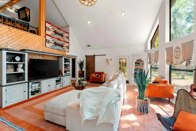 a living room with furniture and a flat screen tv