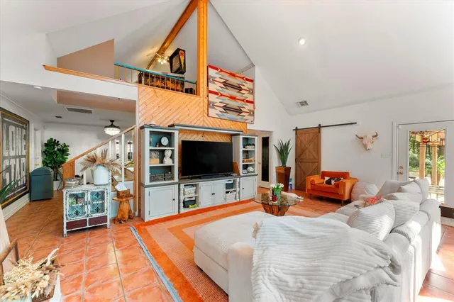 a bedroom with furniture and a flat screen tv