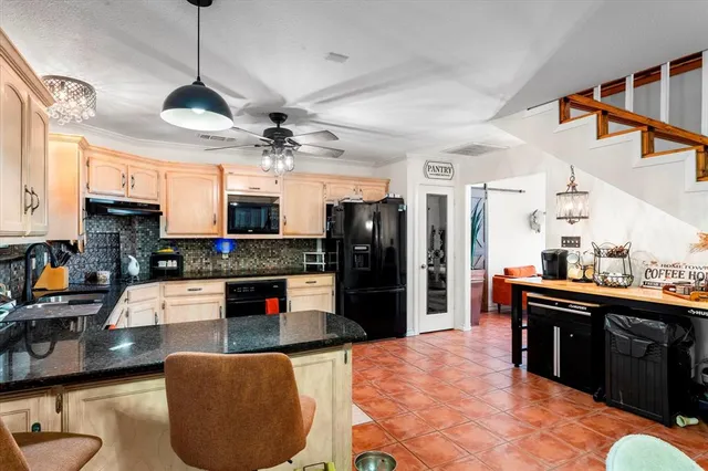 a large kitchen with stainless steel appliances granite countertop a stove and a sink