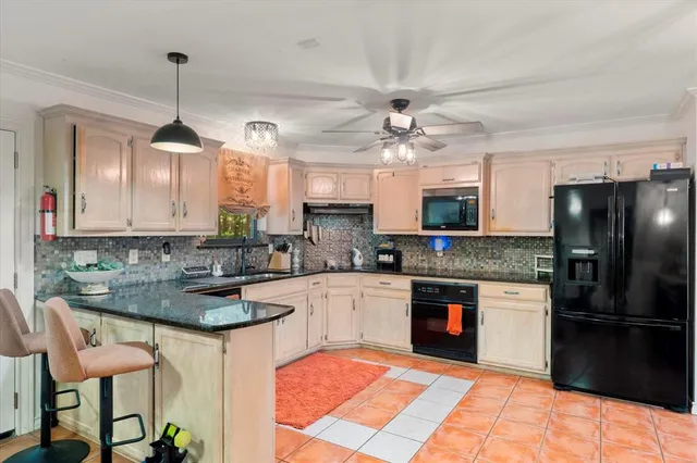 a kitchen with a refrigerator a sink and a stove