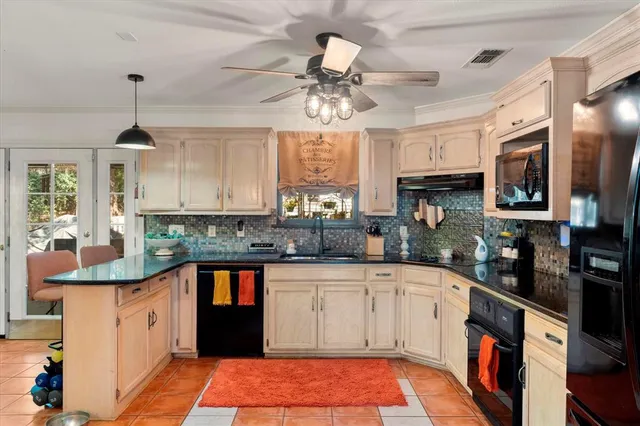 a kitchen with stainless steel appliances granite countertop a sink and cabinets