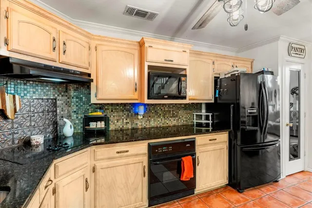 a kitchen with stainless steel appliances granite countertop a refrigerator stove and sink
