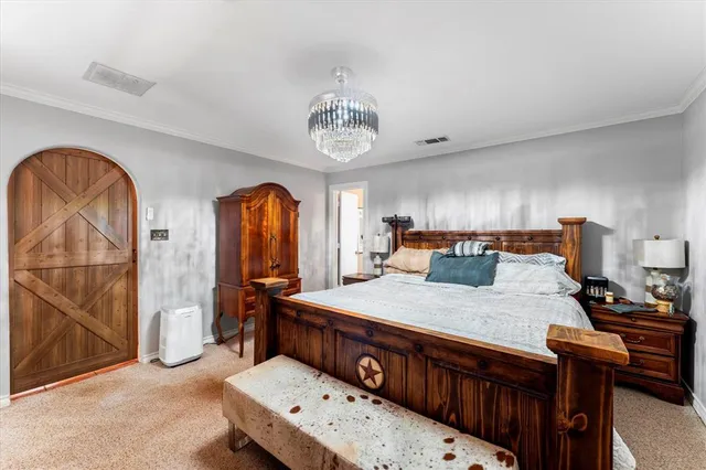 a bedroom with bed and wooden floor