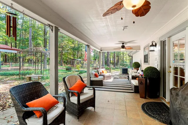 a living room with furniture and a floor to ceiling window