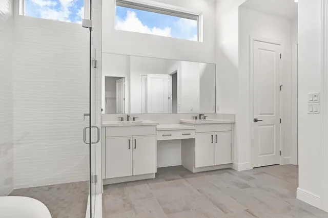 a bathroom with a granite countertop sink mirror and toilet