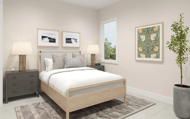 a bedroom with a large bed and a lamp