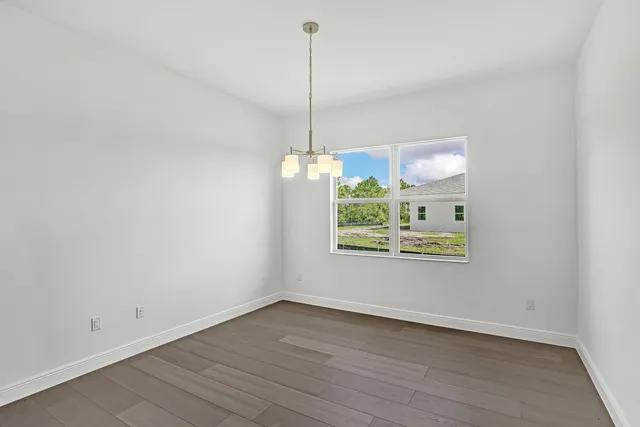a kitchen with a wooden floor and a window