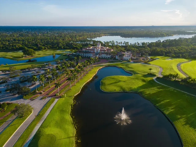 an aerial view of a house with a swimming pool yard and mountain view in back
