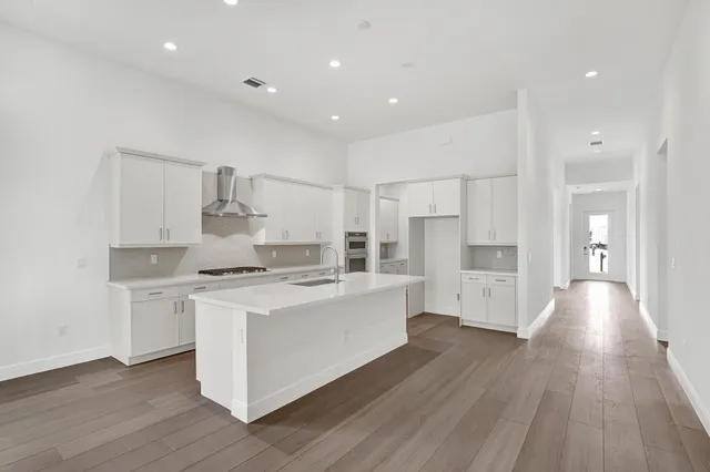 a kitchen with white cabinets and stainless steel appliances