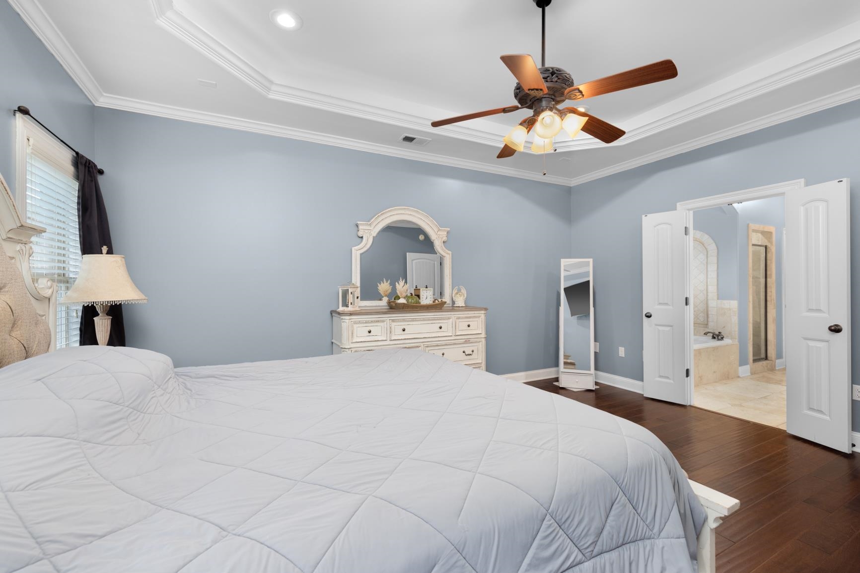 54 Palmer Cove Atoka, TN 38004 - Photo 14 of 40 Bedroom featuring dark wood-type flooring, ceiling fan, ornamental molding, a raised ceiling, and connected bathroom