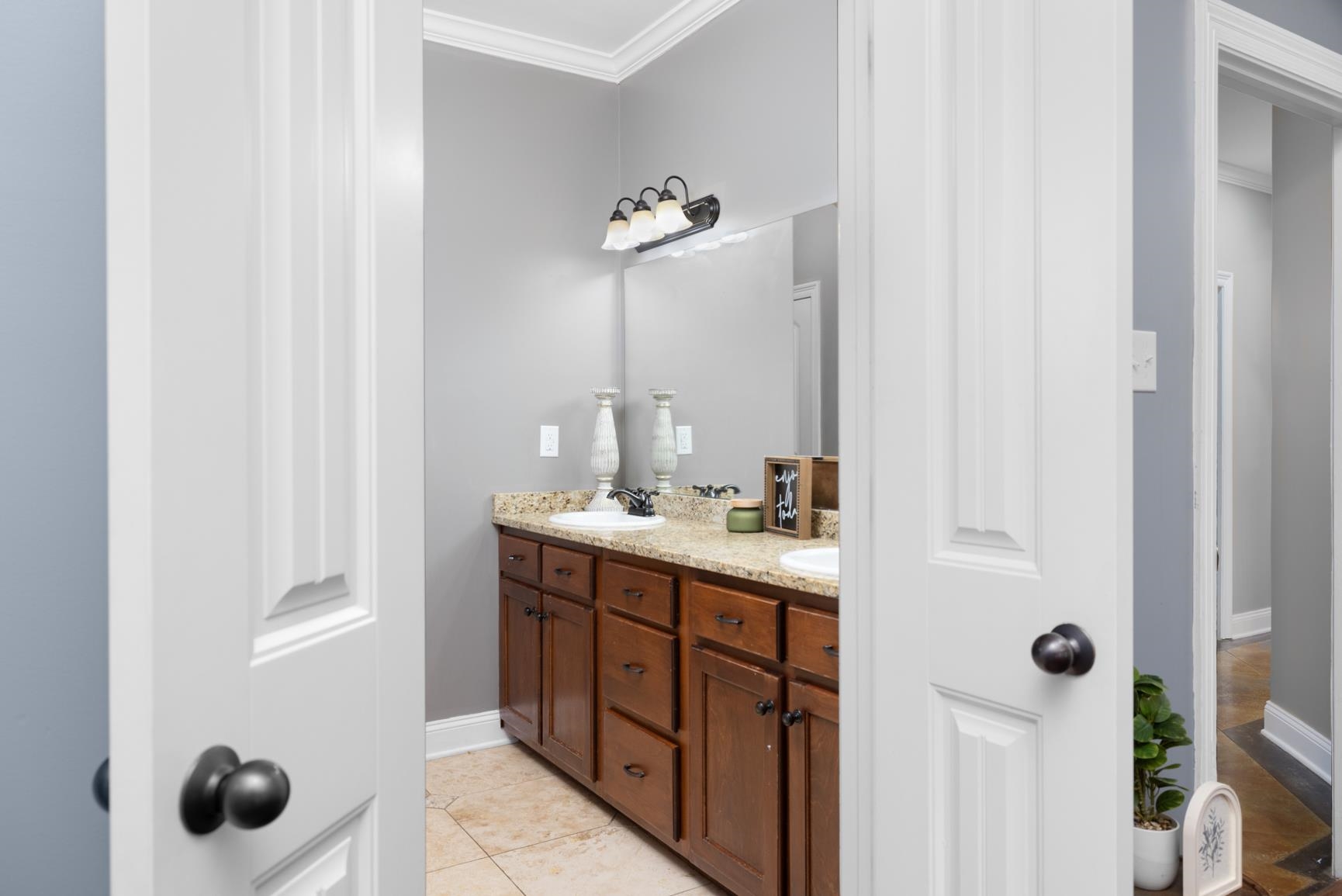 54 Palmer Cove Atoka, TN 38004 - Photo 15 of 40 Bathroom with double vanity, crown molding, and light tile patterned floors