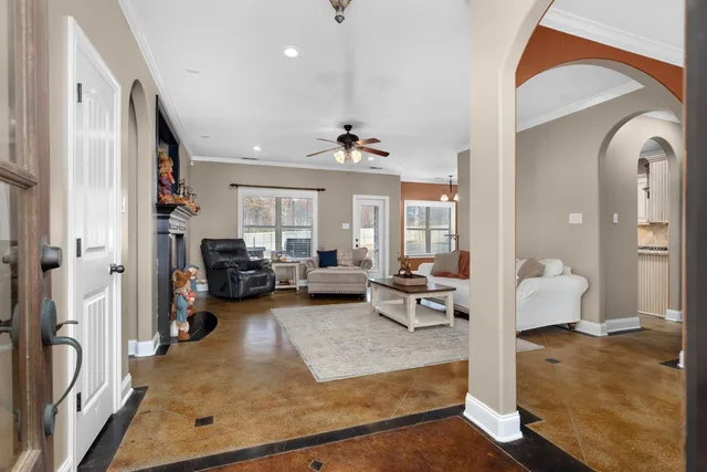 a living room with furniture and a chandelier