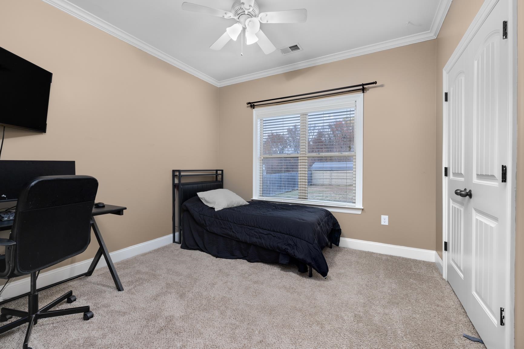 54 Palmer Cove Atoka, TN 38004 - Photo 23 of 40 Bedroom with light carpet, ornamental molding, a desk, and a ceiling fan