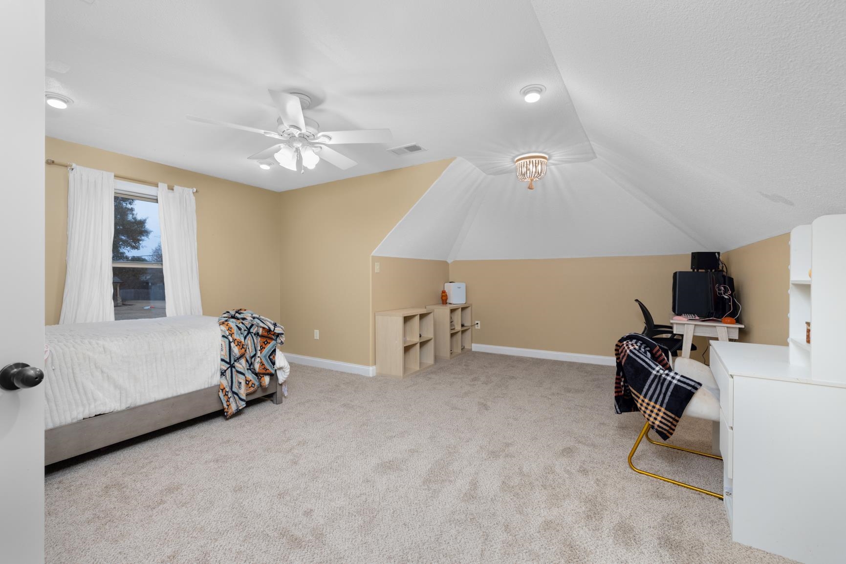 54 Palmer Cove Atoka, TN 38004 - Photo 28 of 40 Bedroom with a desk, light colored carpet, ceiling fan, and vaulted ceiling