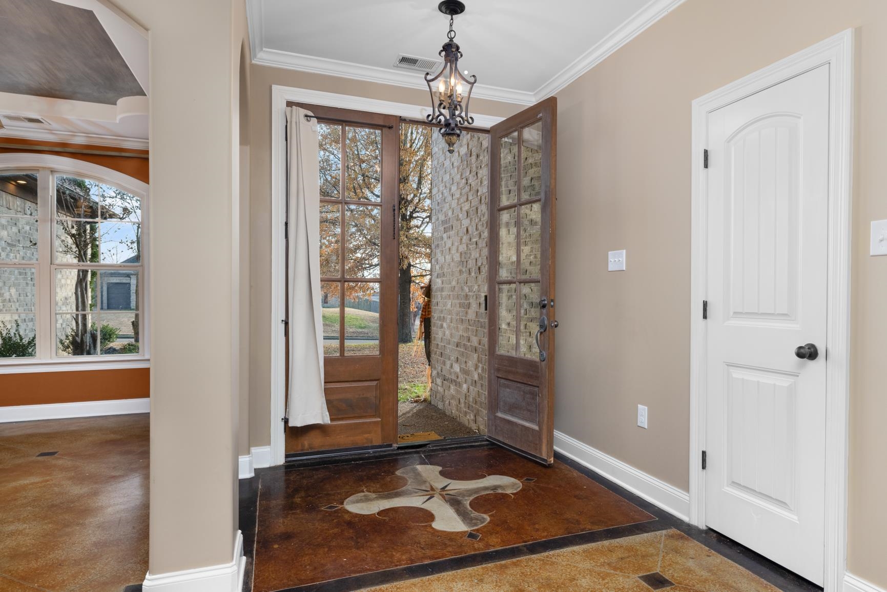 54 Palmer Cove Atoka, TN 38004 - Photo 3 of 40 Entryway featuring ornamental molding, a chandelier, and concrete flooring