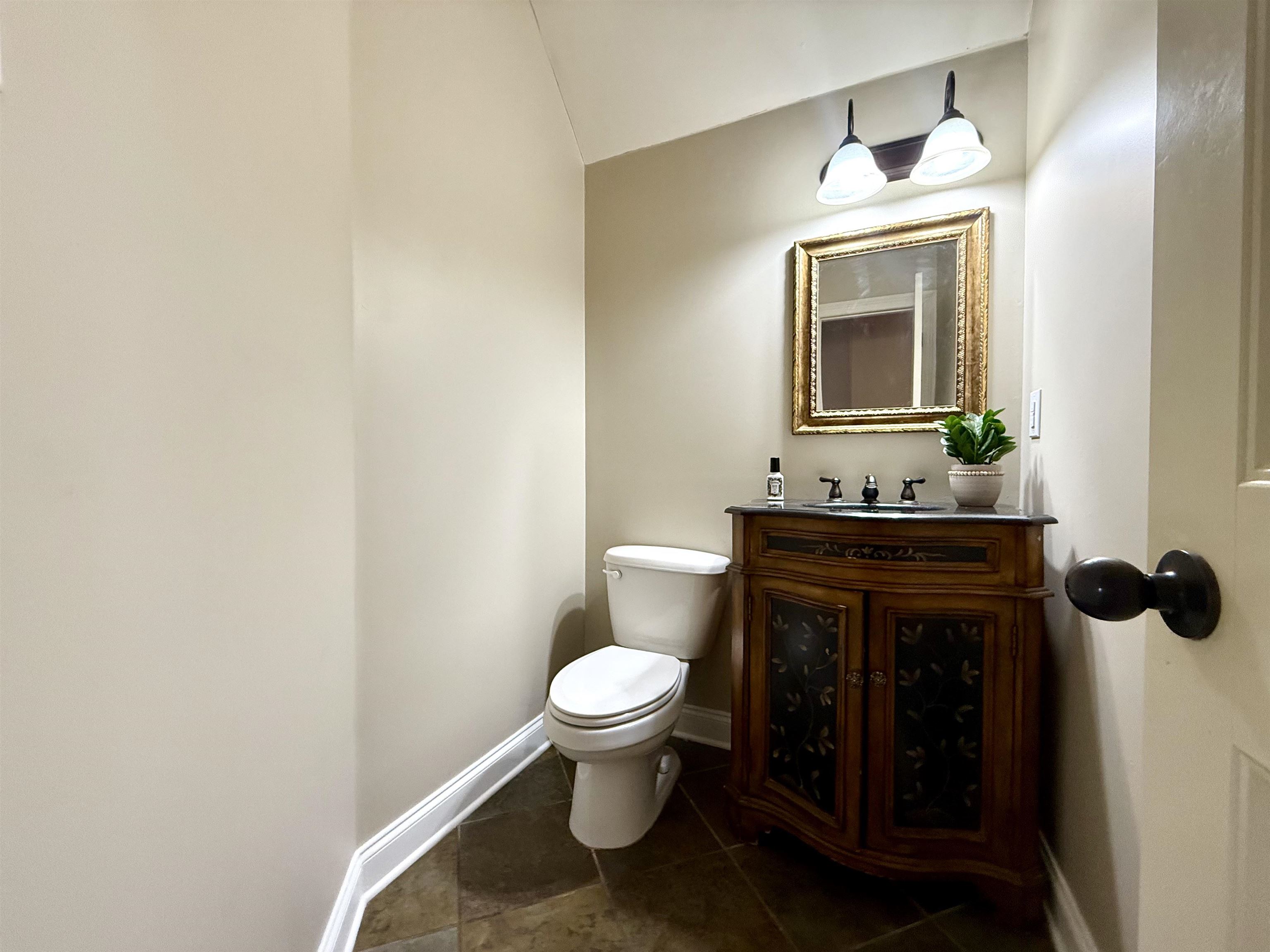 54 Palmer Cove Atoka, TN 38004 - Photo 31 of 40 Bathroom with vanity, dark tile patterned floors, and lofted ceiling