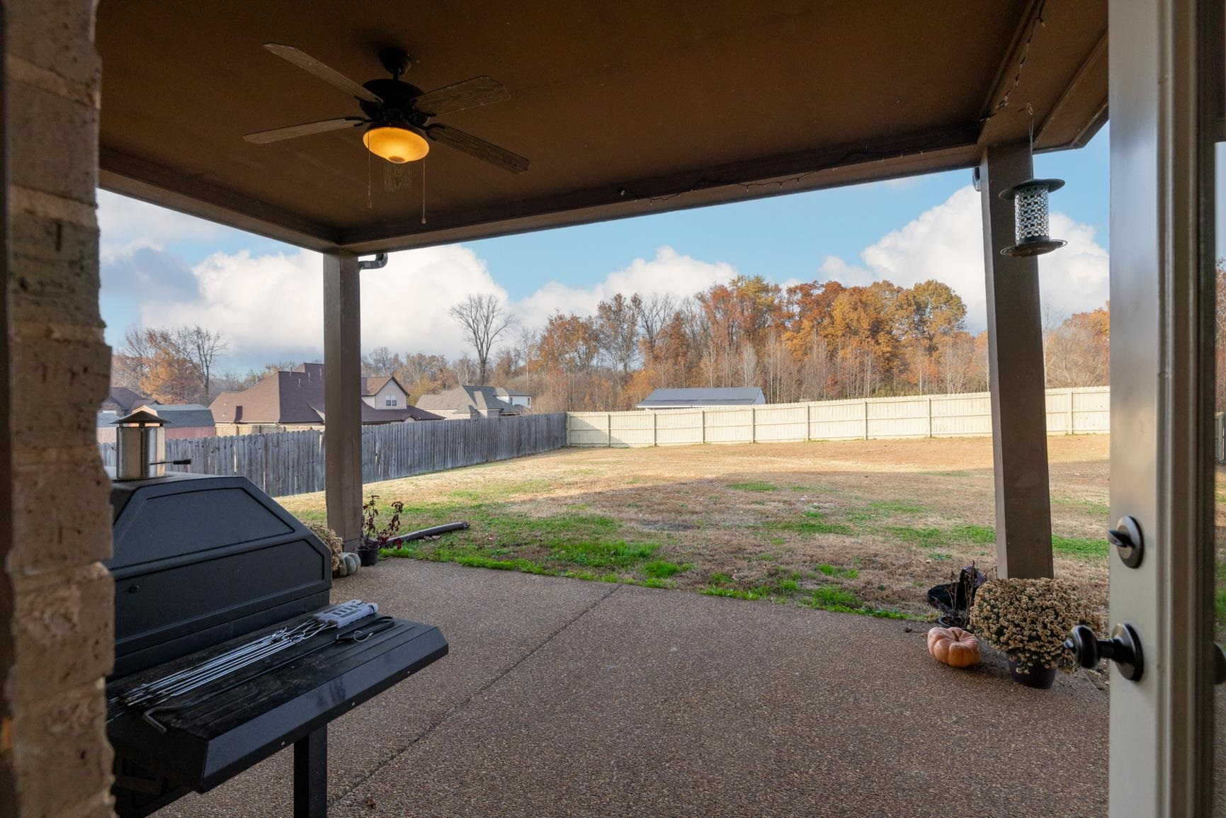 54 Palmer Cove Atoka, TN 38004 - Photo 32 of 40 Fenced backyard featuring a ceiling fan and a patio