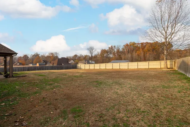 a view of a brick building next to a yard