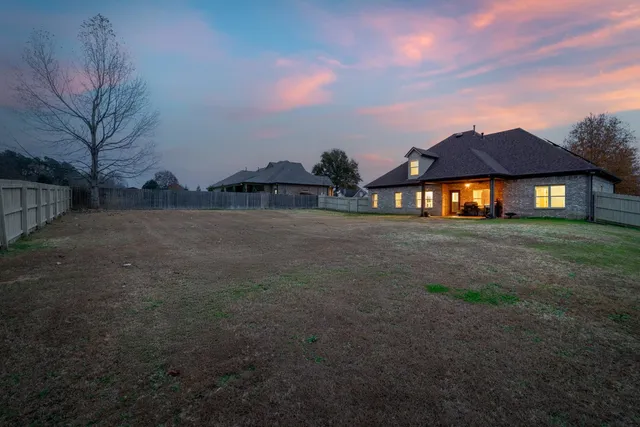 a view of a house next to a yard