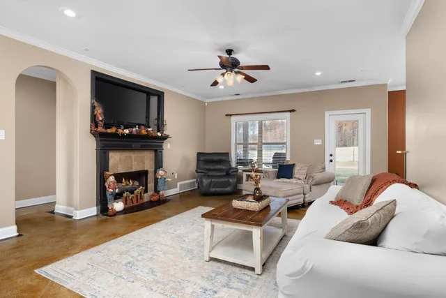 a living room with furniture and a fireplace