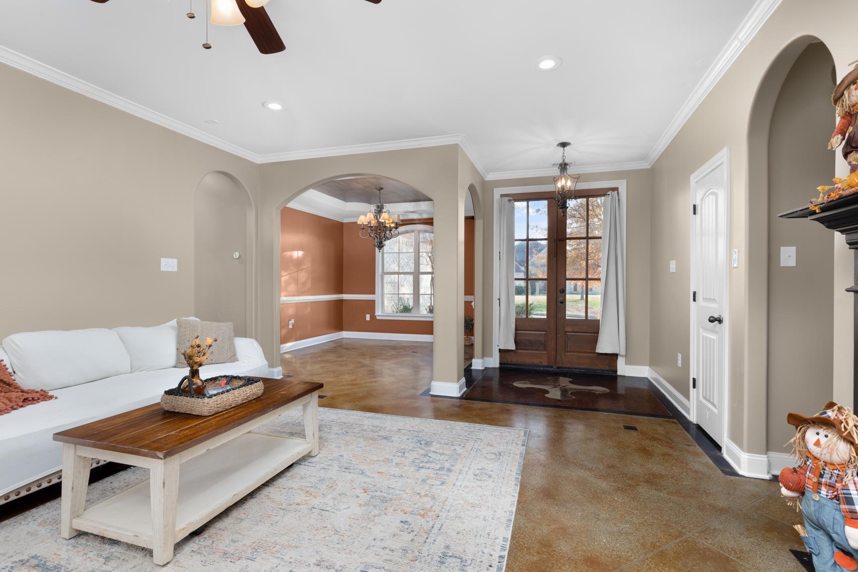 54 Palmer Cove Atoka, TN 38004 - Photo 6 of 40 Foyer entrance featuring arched walkways, a chandelier, concrete flooring, french doors, and ornamental molding