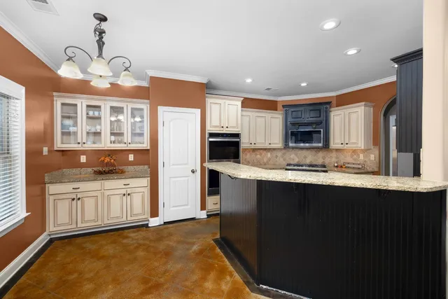 a kitchen with stainless steel appliances granite countertop a stove and a sink