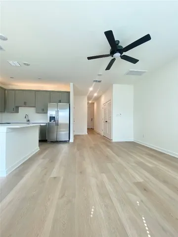 a view of a kitchen with a sink and cabinets