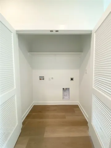 a view of a room with rack on the wall and a window