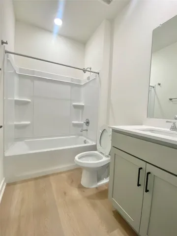 a bathroom with a toilet a sink and a shower