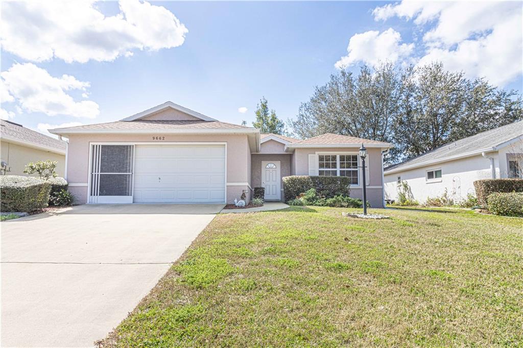 9662 Southwest 92nd Place Road Ocala, FL 34481 - Photo 1 of 1 a front view of a house with a garden