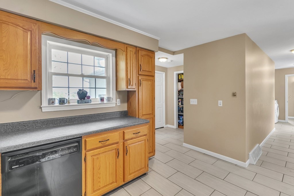 159 Hadley Street Springfield, MA 01118 - Photo 17 of 42 a kitchen with granite countertop a sink and a refrigerator