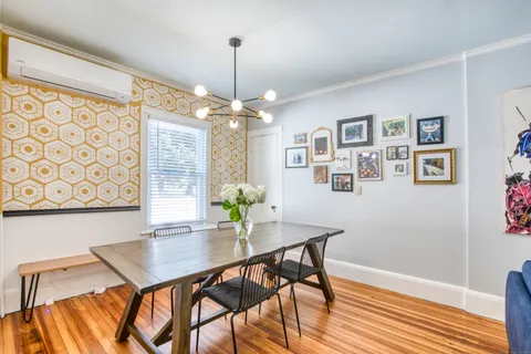 a view of a dining room with furniture and wooden floor