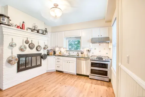 a kitchen with stainless steel appliances granite countertop a stove and a sink