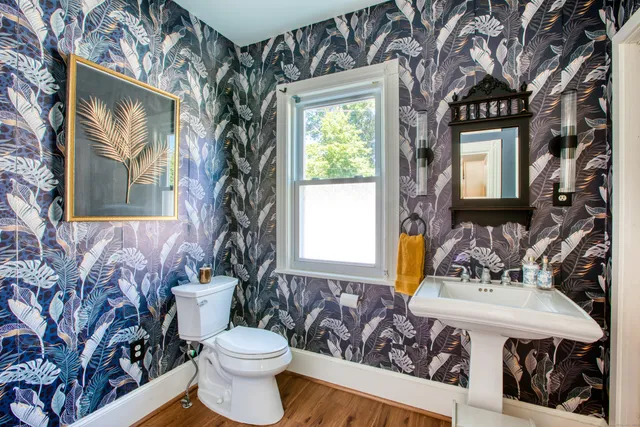 a bathroom with a toilet sink and mirror