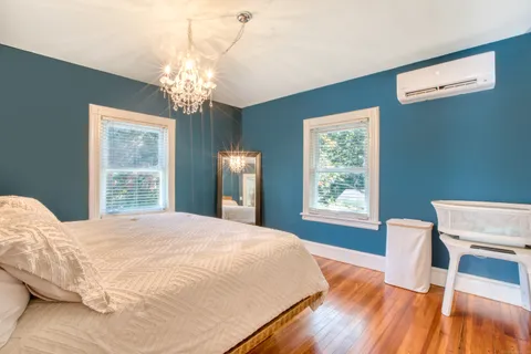 a bedroom with a bed and a window