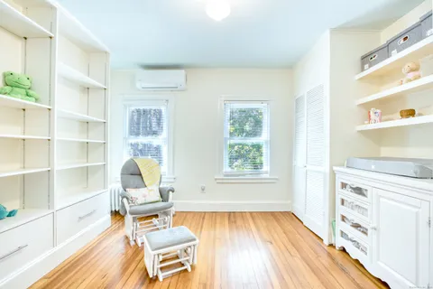a view of a workspace with furniture and a window