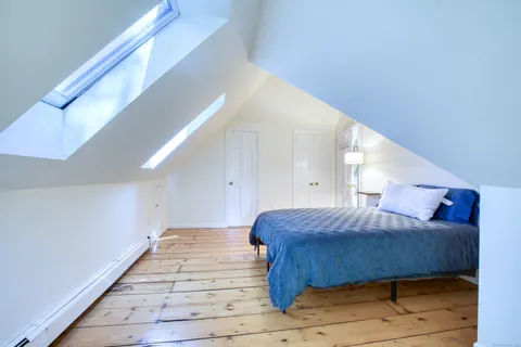 a bedroom with a bed and a ceiling fan