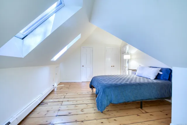 a bedroom with a bed and a ceiling fan