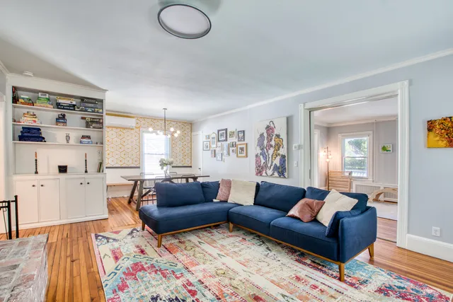 a living room with furniture and a rug