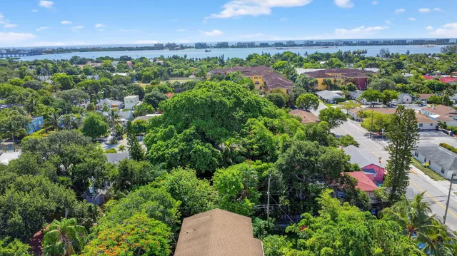 an aerial view of residential house with outdoor space and trees all around