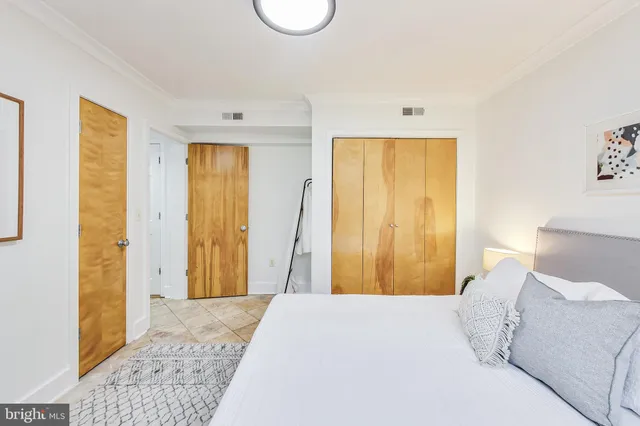 a bedroom with a bed and a dresser