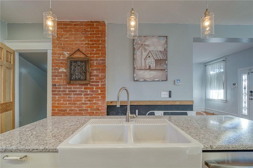 629 George Street Coraopolis, PA 15108 - Photo 8 of 25 Island sink, exposed brick, updated lighting and new 6 panel wood doors to the basement are unique additions to the kitchen.