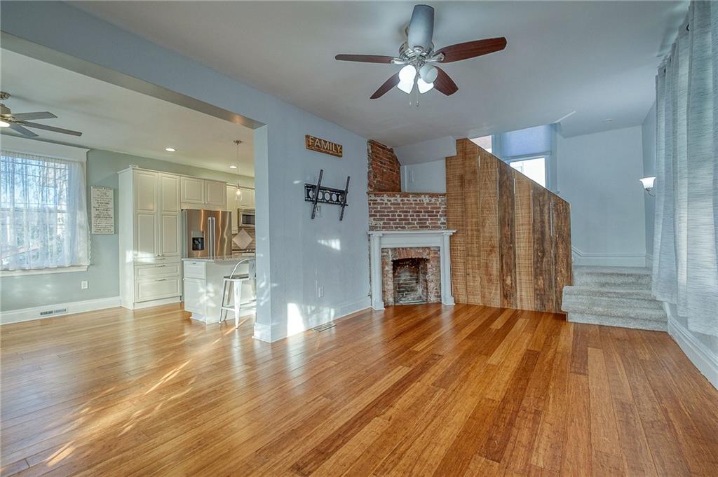629 George Street Coraopolis, PA 15108 - Photo 10 of 25 Open floor plan with decorative fireplace and barn wood accents. totally redone stairs to the 2nd floor.