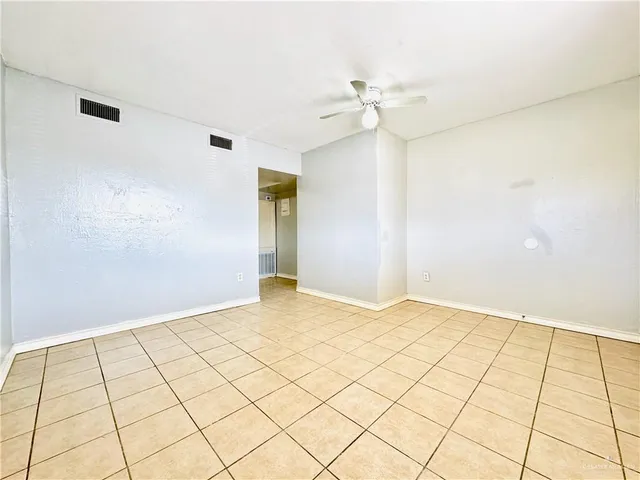 a kitchen with granite countertop a sink a stove and a refrigerator